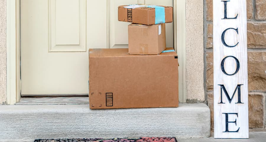 Boxes by the door of a residence with a welcome sign in Lancaster